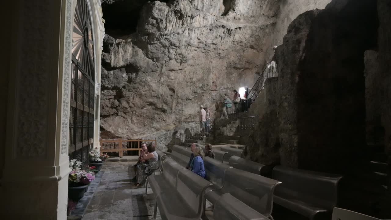 Catholics praying in the chapel of the Virgin of the Cave of the Sanctuary of the Holy Cave, in Altura, Castellón