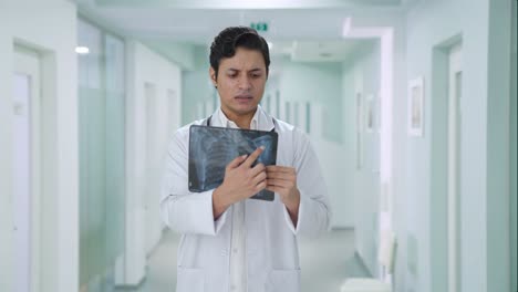 confused indian doctor explaining x ray report to patient