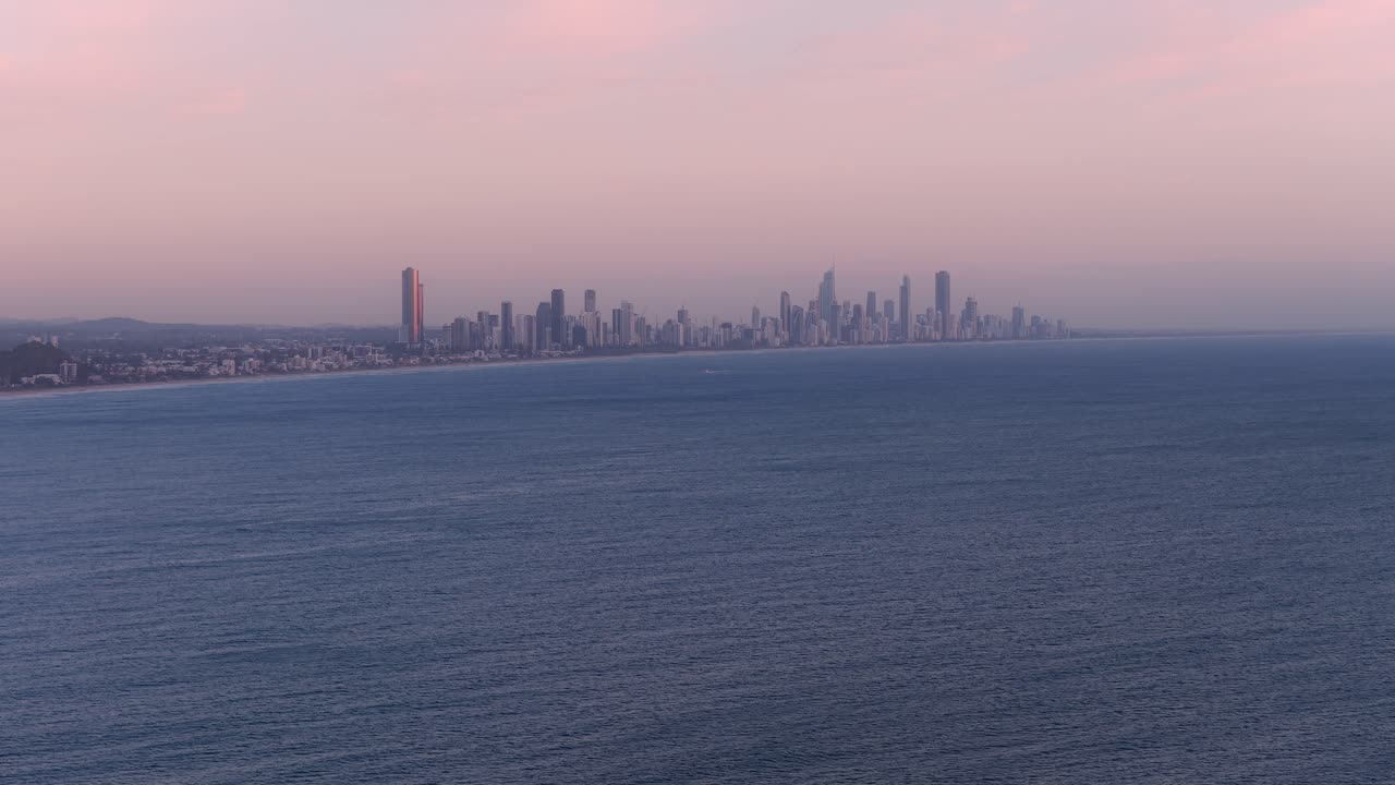 Surfers Paradise Skyline In Gold Coast, QLD, Australia - Towering Buildings Against Sunset Sky With Pacific Ocean In Foreground. wide drone shot