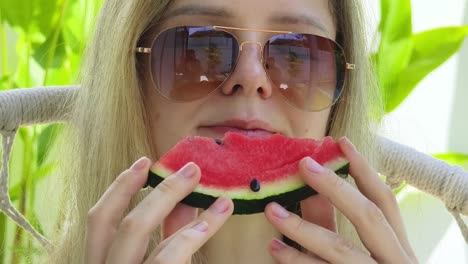 woman eating watermelon outdoors