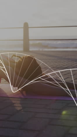 dna structure against african american fit woman performing yoga on the promenade