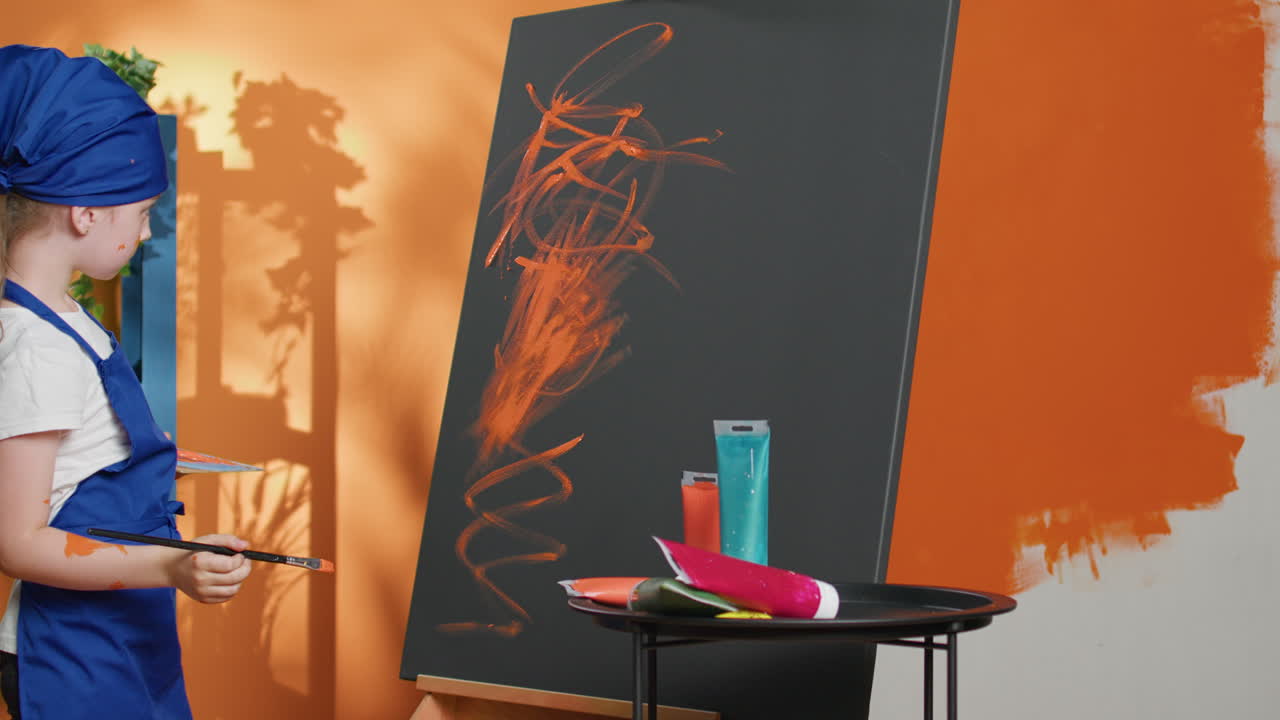 Girl Painting on Canvas in Studio