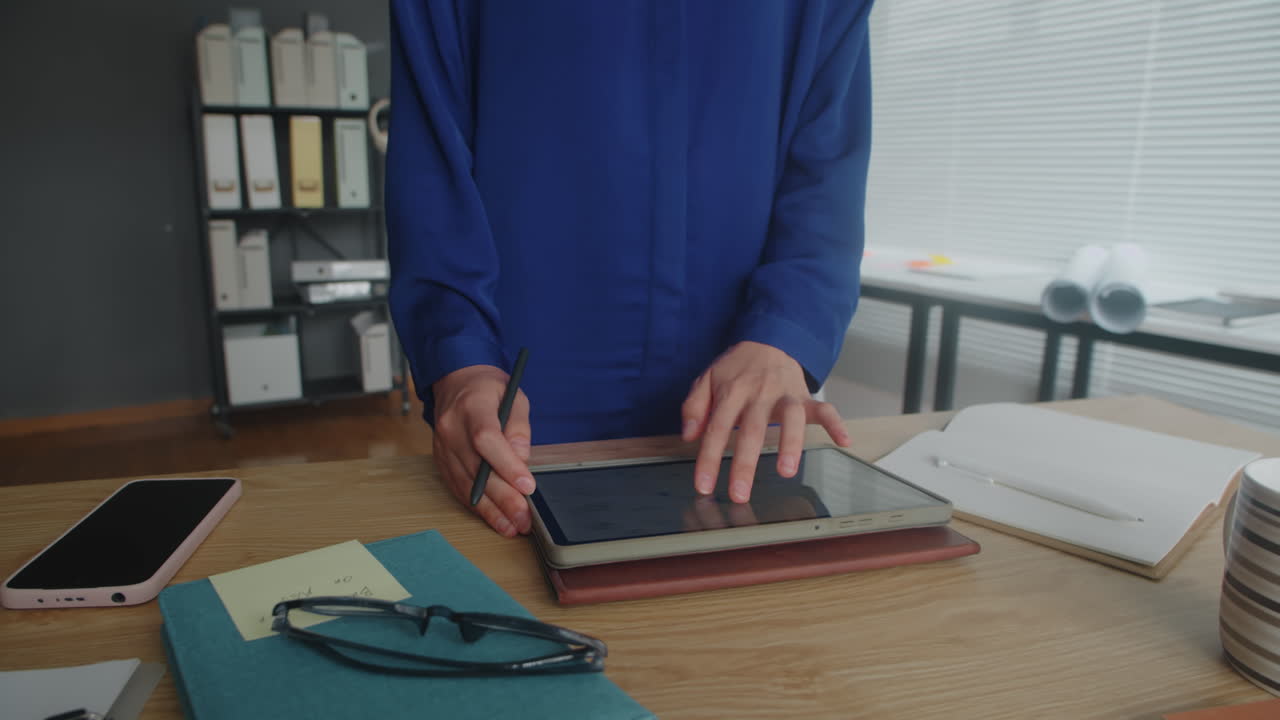 Unrecognizable Businessperson Working on Report on Tablet