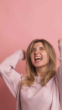 woman celebrating energetically raising fists