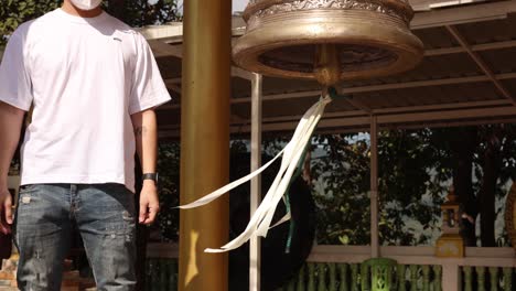 person engaging with a rotating kinetic sculpture