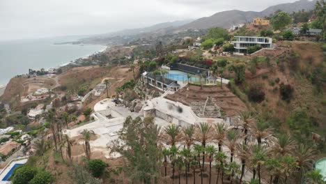 descending aerial close-up shot of a hillside mansion near las flores canyon that was severely affected by the palisades fire in malibu, california. 4k