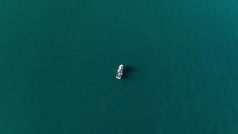 Single-fishing-vessel-in-calm-cyan-arctic-ocean