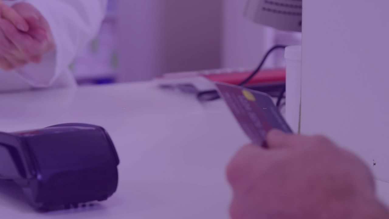 Customer extending card, staff running card through terminal, completing retail payment at counter