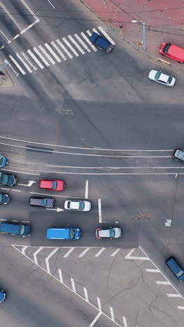 movement of cars at crossroads in a small town. aerial view of highway crossroads. vertical video