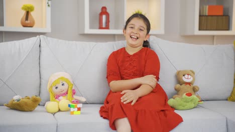 Girl-child-smiling-at-camera-at-home.