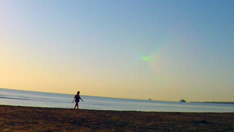 Ladies-walking-along-the-beach-at-sun-rise-on-a-beautiful-day