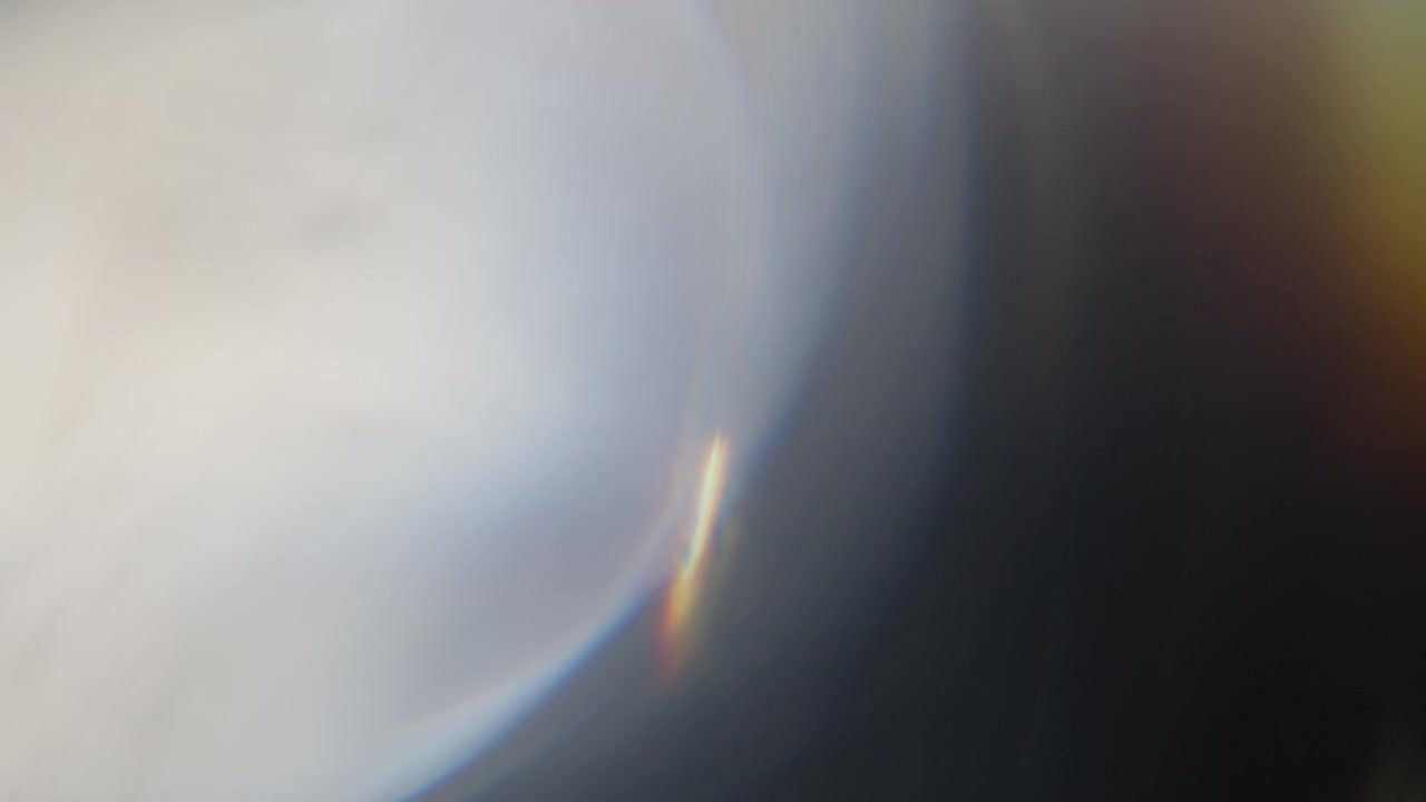 Fast flashing prism light leaks transition on a black background