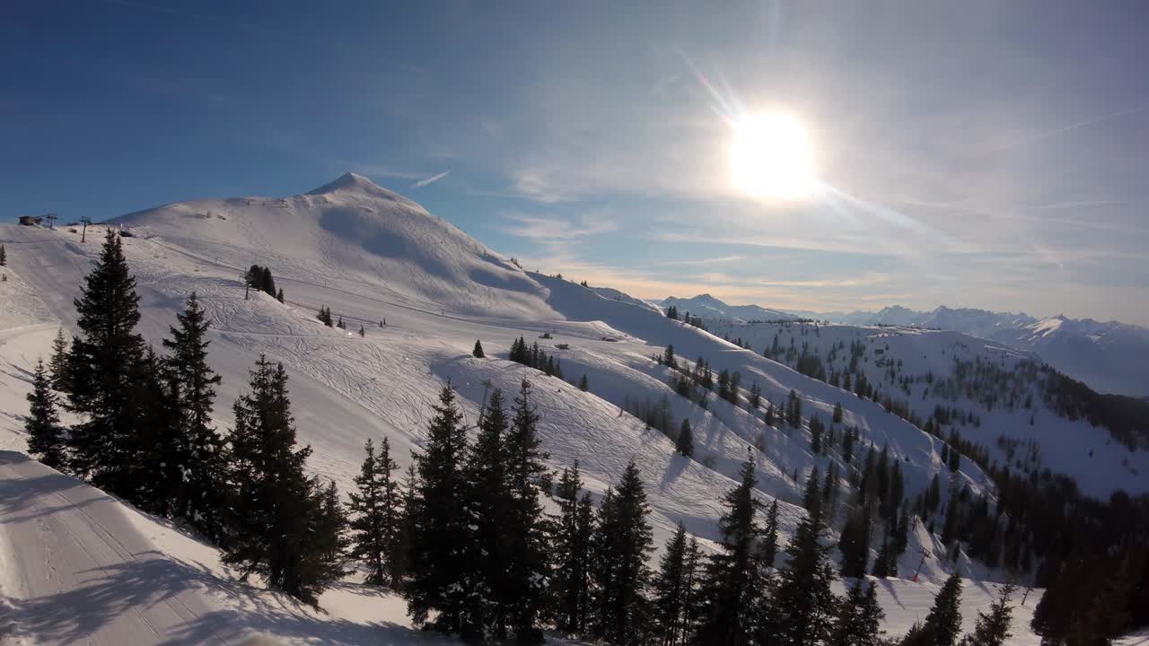 Snowcat groomers grooming ski slopes and pistes for skiers and snowboarders in Ski Juwel Alpbachtal Wildschönau Austria tyrolean ski area resort in time-lapse landscape sunny view