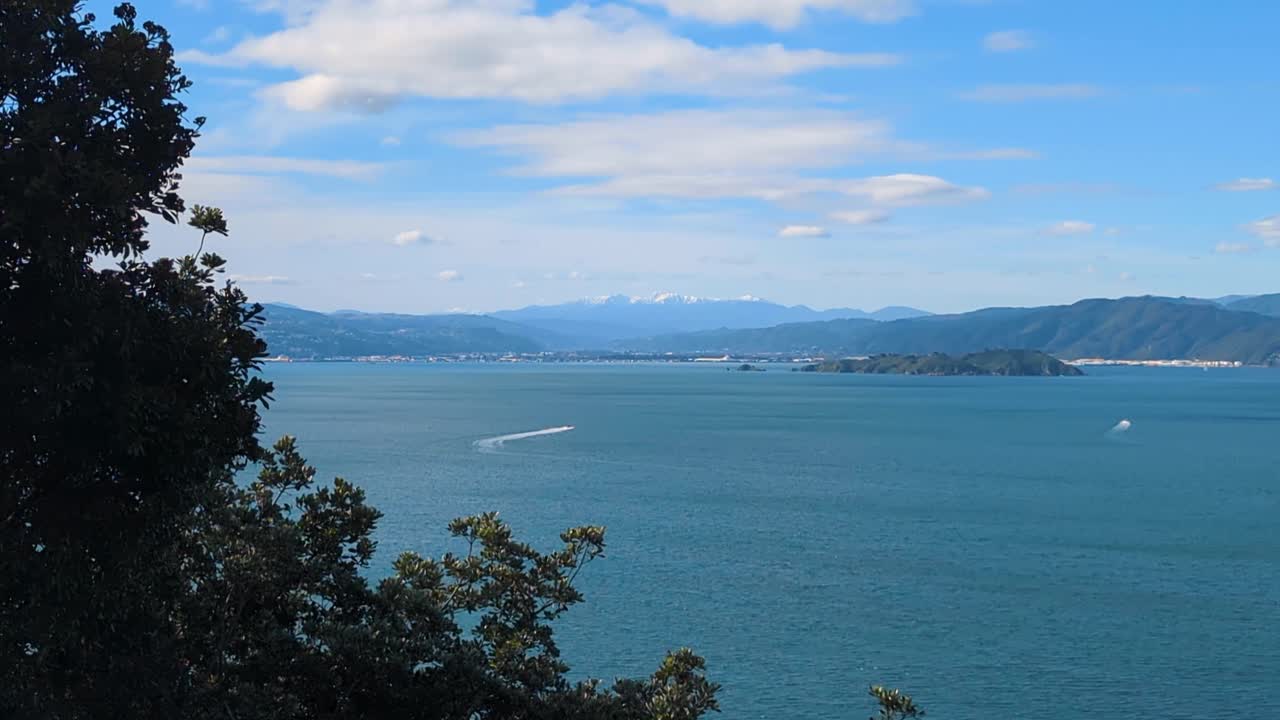 Scenic view of Wellington harbour, Matiu Somes Island, and snowcapped mountain ranges in Wellington, New Zealand Aotearoa
