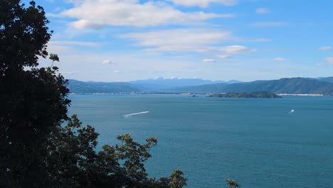 scenic view of wellington harbour, matiu somes island, and snowcapped mountain ranges in wellington, new zealand aotearoa