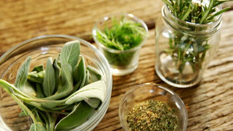 various herbs in a jar on wooden table 4k