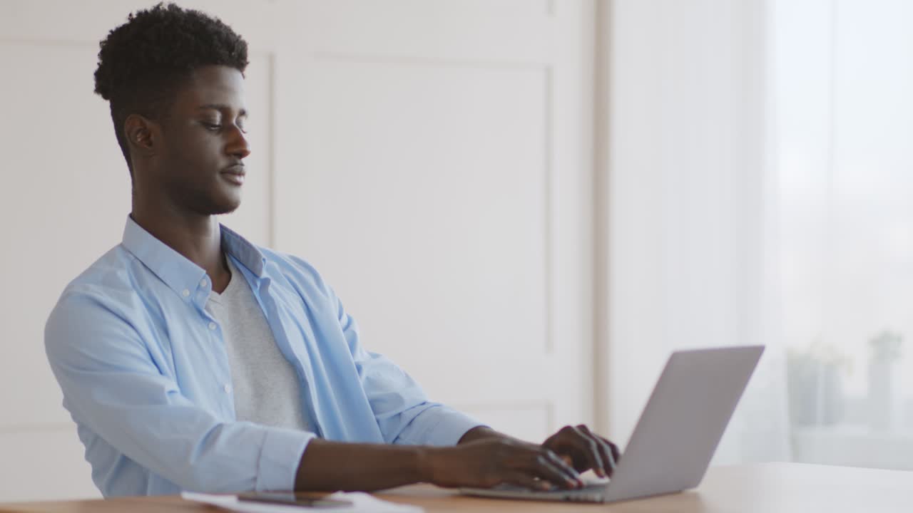 Young Man Working on Laptop