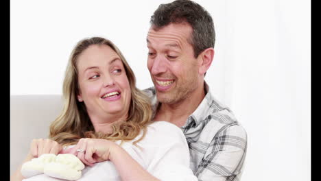 marido sonriendo con su esposa embarazada