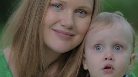 young mother and lovely little son outdoor portrait