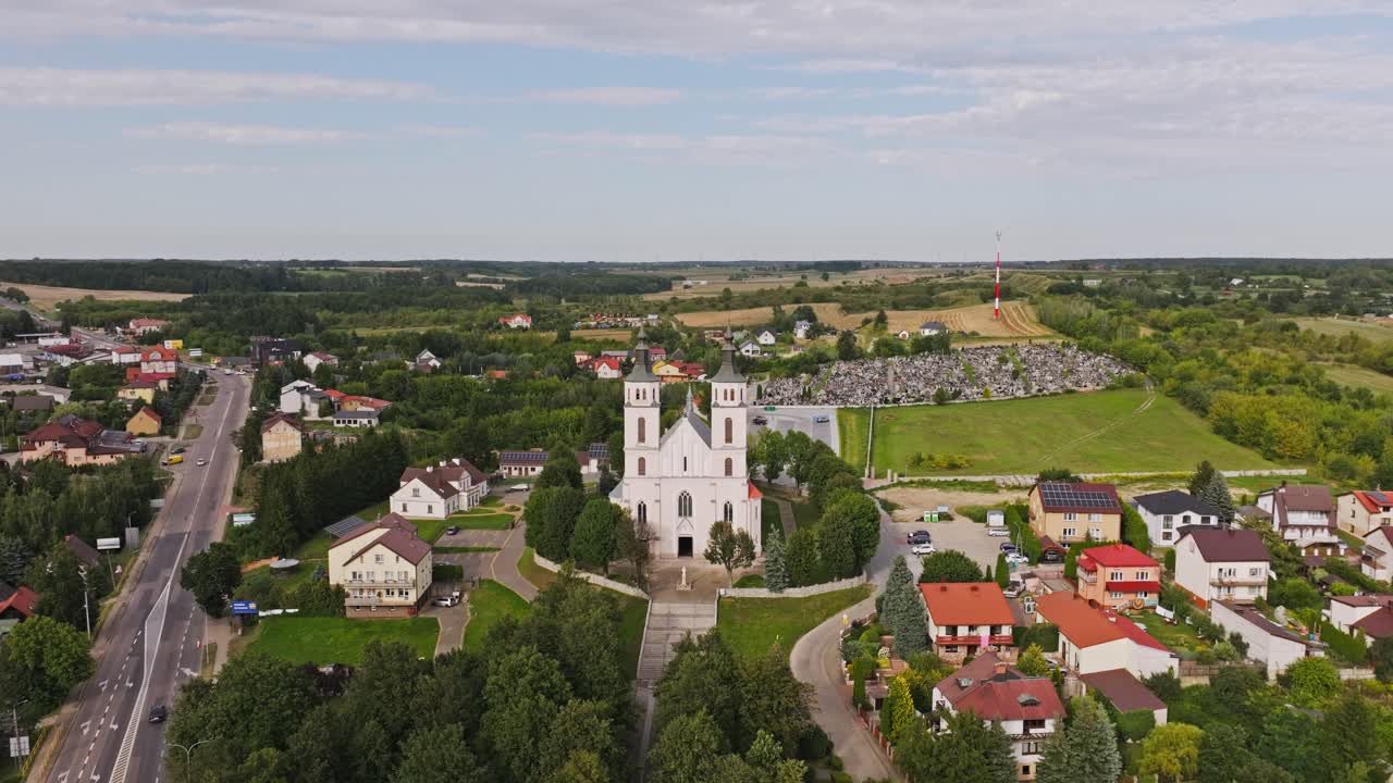 Aerial pullback from Piatnica Poduchowna church symbolizing tradition, Poland