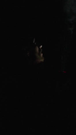 figure in the dark with a light source