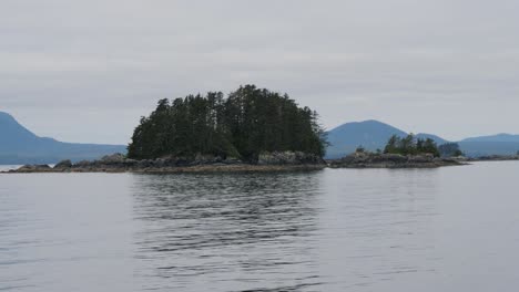 small rocky islands covered with pine trees. sailing around sitka, alaska, alexander archipelago.
