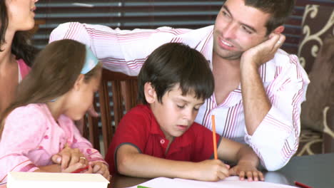 parents watching their chidren doing homework