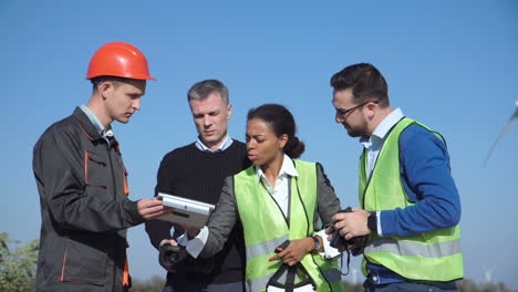 team discussing project at a wind farm