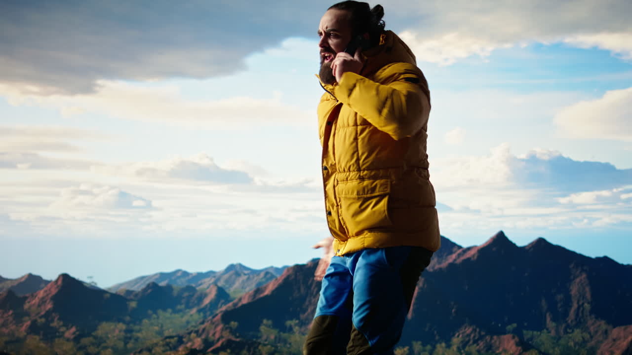 Clumsy foolish hiker dropping his phone in search of signal on mountain top