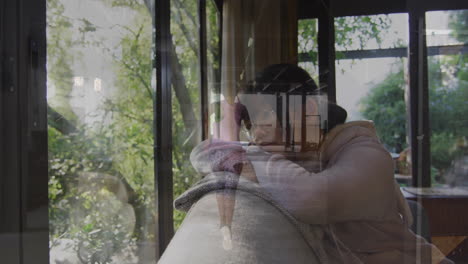 Relaxing on couch, person watching animation with nature outside large windows