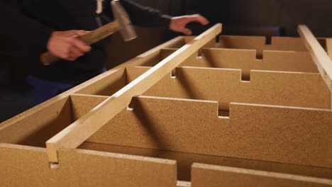 Carpenter assembling wooden furniture
