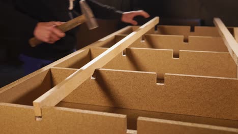 carpenter assembling wooden furniture