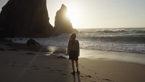 woman on a beach at sunset