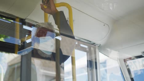 african american senior man wearing face mask travelling in the bus