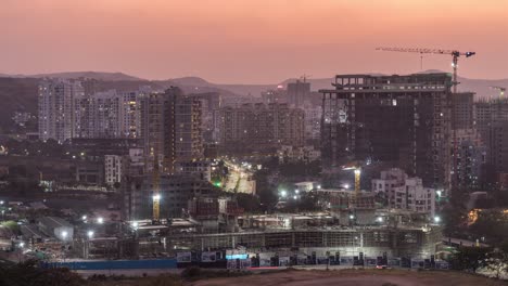 under construction work at a site, day to night time lapse of cityscape view, development of city of pune, maharashtra, india