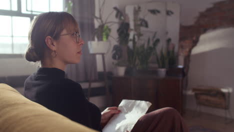 woman reading a letter at home