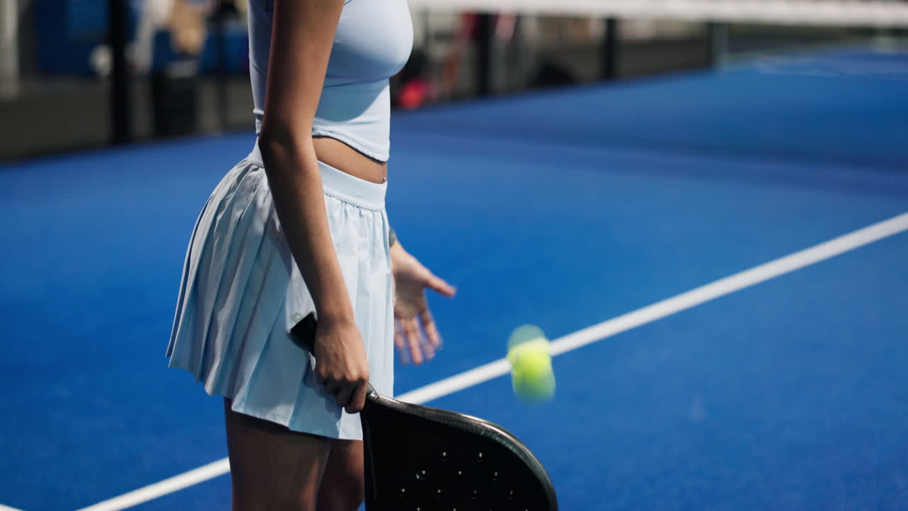 Woman playing padel on a court