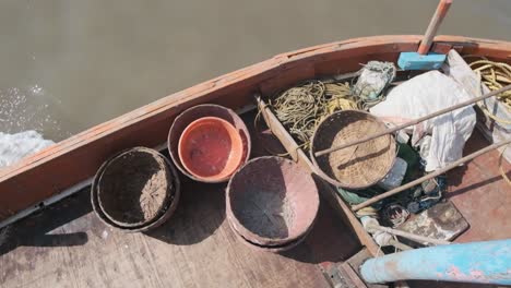 overhead-shot-of-small-fishing-baskets-on-little-sea-fishing-boat-slow-motion