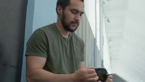 runner putting sock on prosthetic leg before training