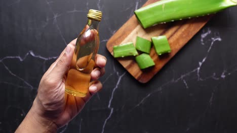 aloe vera oil in hand, skincare product