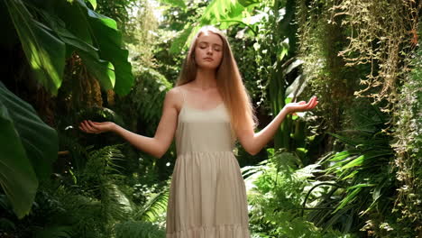 woman meditating in lush green garden