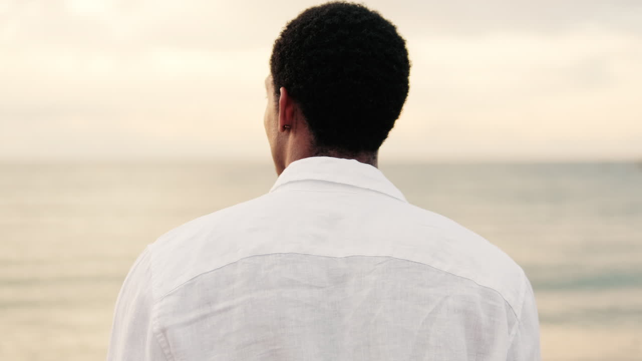 Rear View of Man Looking at the Calm Ocean Horizon