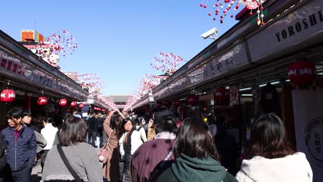 crowded shopping area with pedestrians and stores