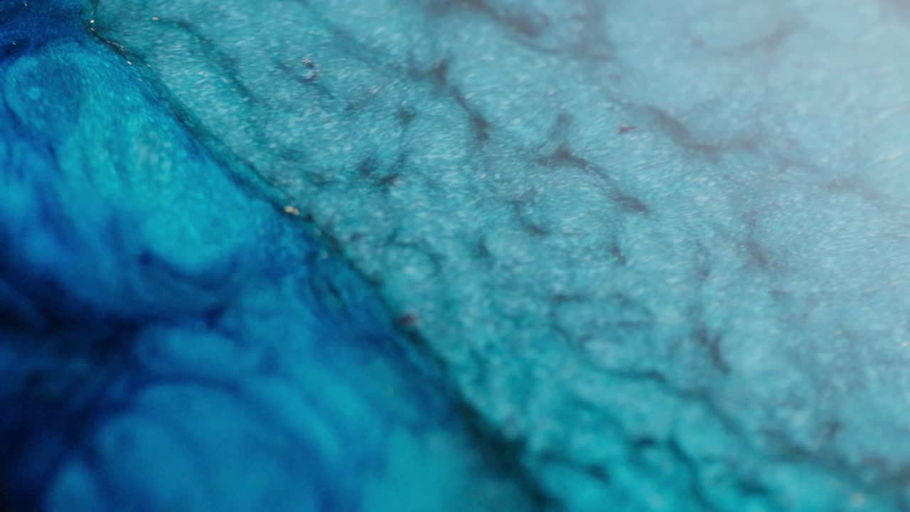 Dense ink in motion simulating the sea waves movement