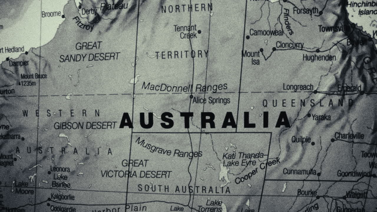 A detailed close-up of a map of Australia, highlighting its states, territories, deserts, and major cities