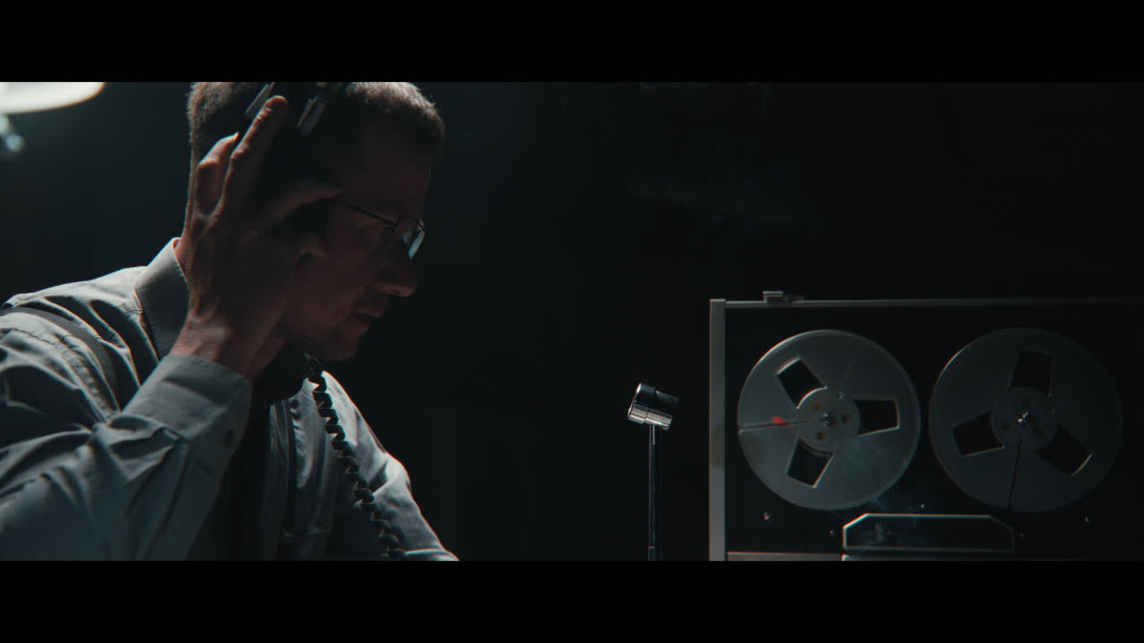 An intelligence officer listens to the wiretap recordings