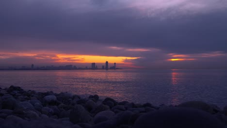 sea and sunset on the background of resort town. batumi in georgia.