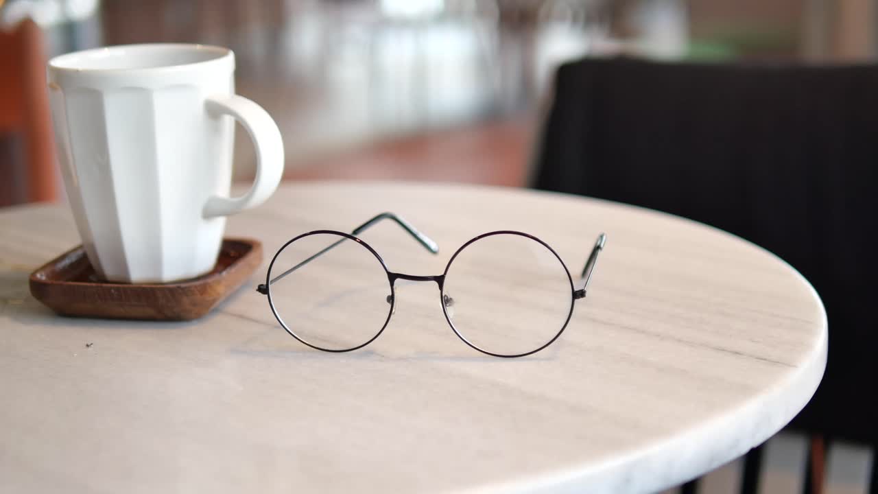 Coffee cup and eyeglasses on a table