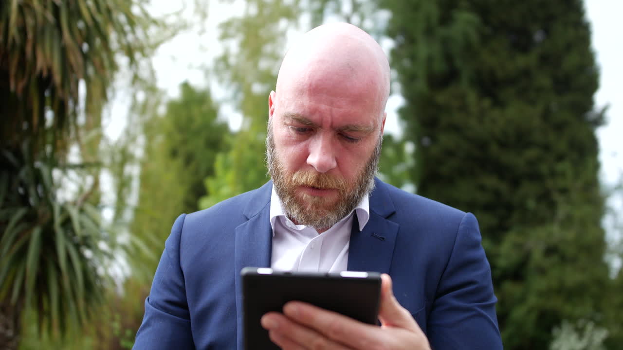 Angry frustrated man throwing tablet down in anger