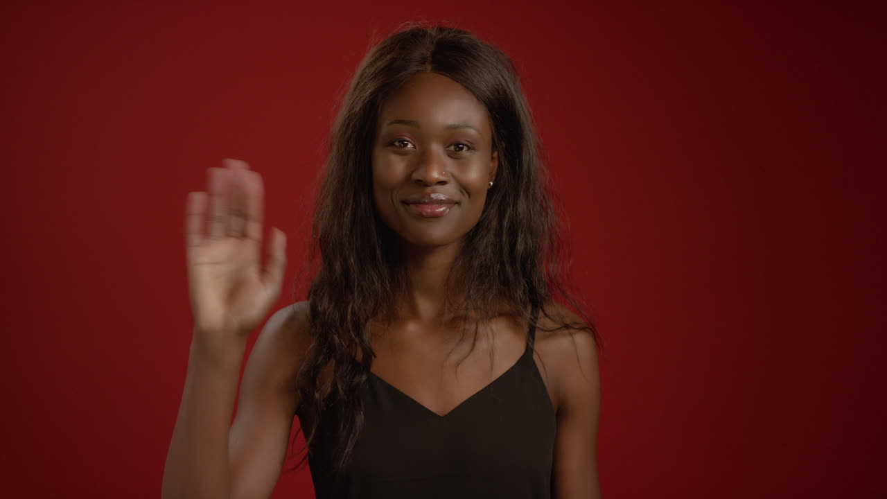 Woman Smiles and Waves at Camera